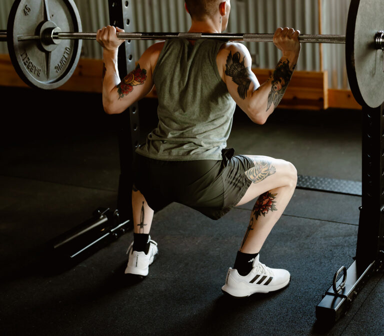 male working out legs using a barbell