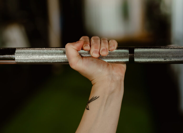 hand holding a barbell