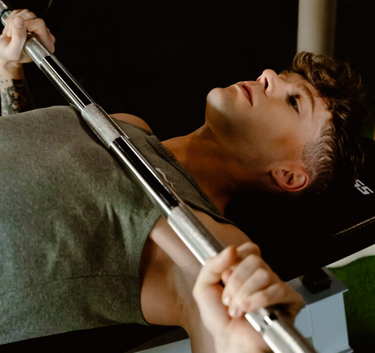 person bench pressing a barbell