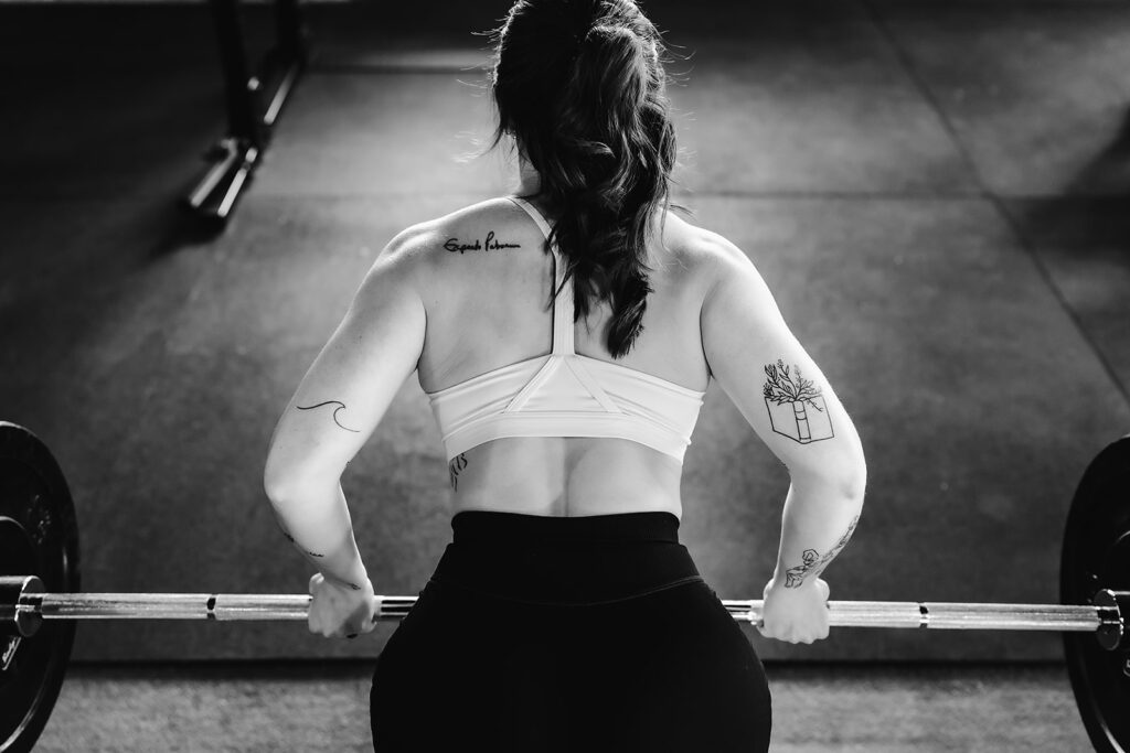 woman performing a barbell row