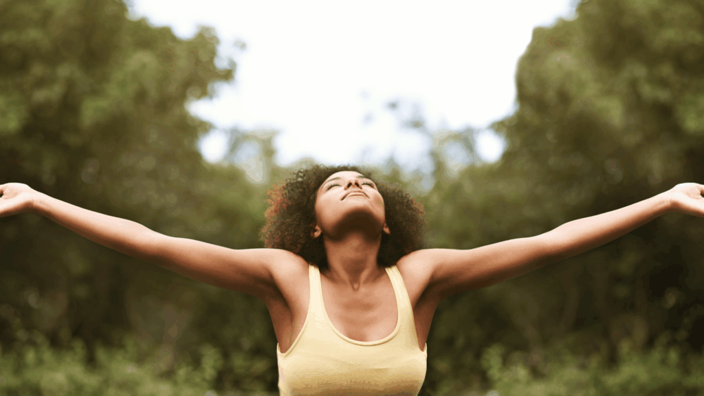 woman with arms outstretched and joyful